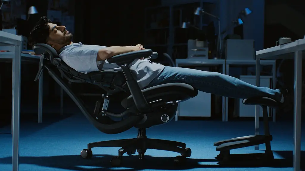 Guy leaning all the way back on the chair.